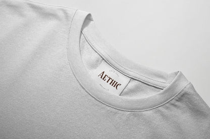 Colour_White t-shirt with 'AETHIC' label on a light gray background