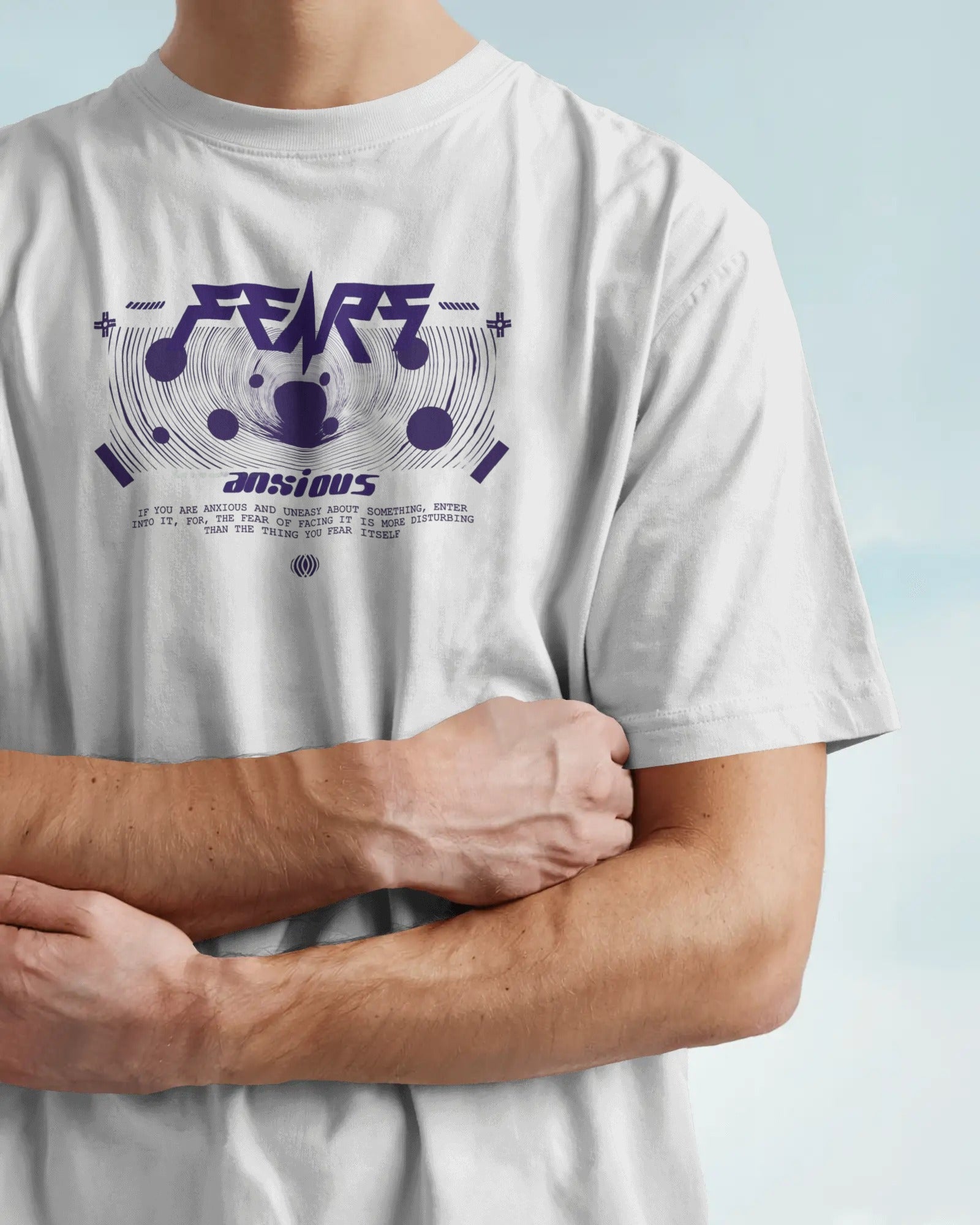 Person wearing a Colour_White t-shirt with purple text and graphics on a light blue background